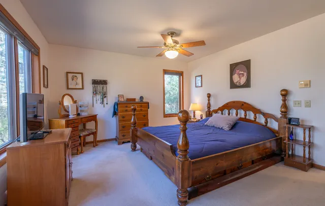 a bedroom with a bed and a chandelier