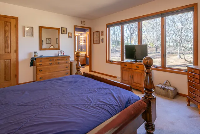 a bedroom with furniture and a window