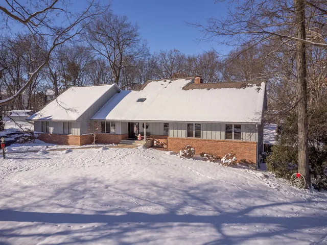 a view of a house with a yard covered in snow