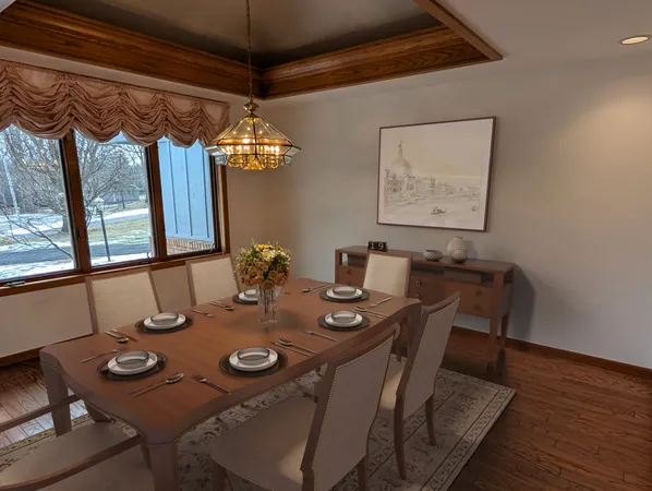 a view of a dining room with furniture window and wooden floor