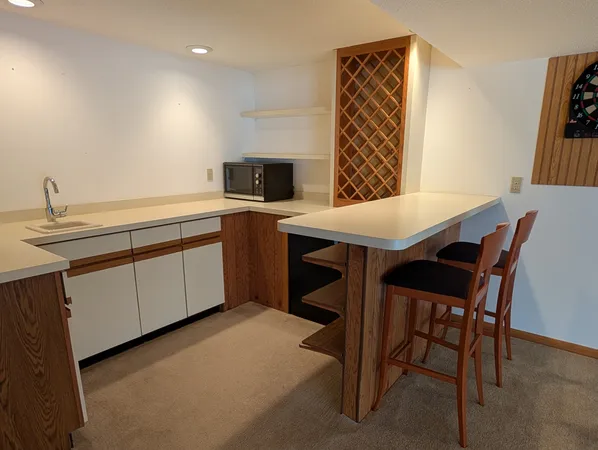 a view of a kitchen with a table and chairs