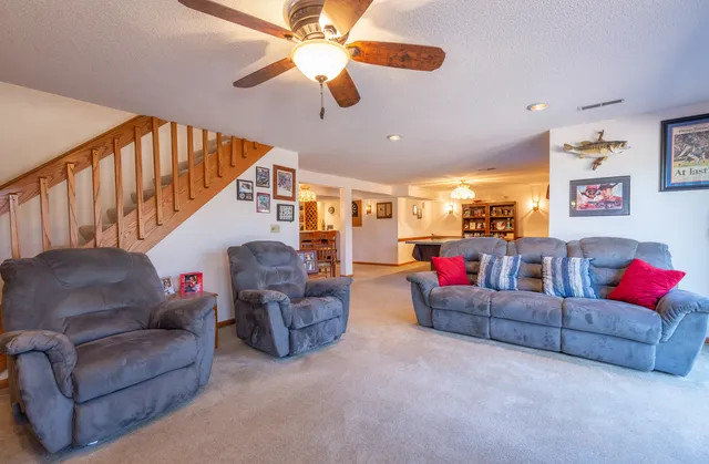 a living room with furniture and a chandelier