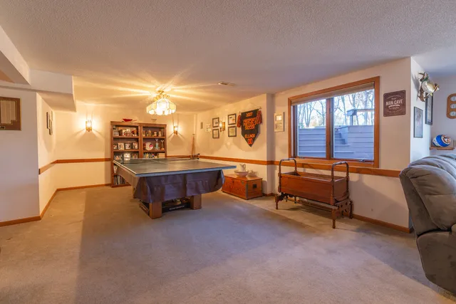 a living room with furniture and a pool table