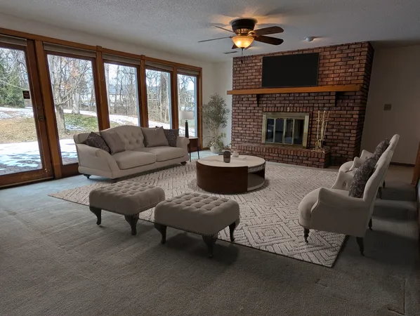 a living room with furniture and a fireplace