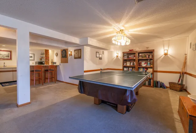 a room with pool table and windows