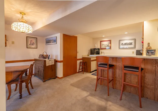 a view of a dining room with furniture and a chandelier