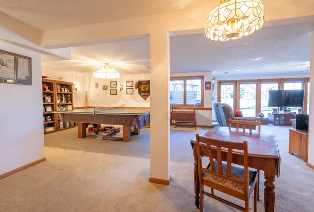 a view of a dining room with furniture and a chandelier