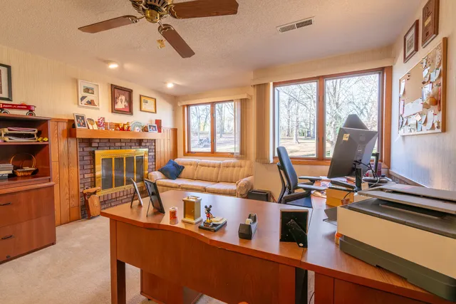a living room with furniture a flat screen tv and a window