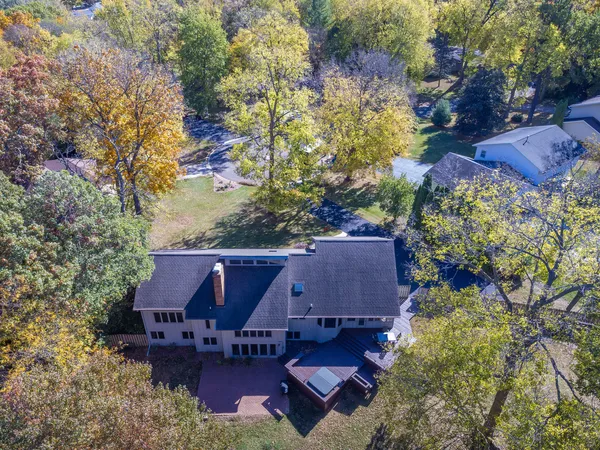 an aerial view of a house with yard swimming pool and outdoor seating