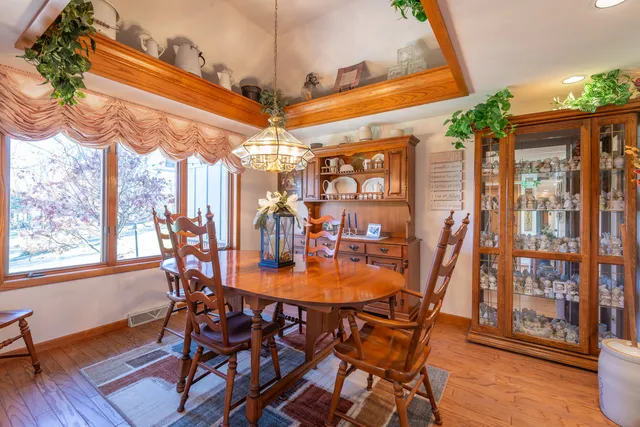 a view of a dining room with furniture wooden floor and chandelier