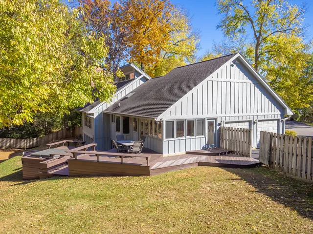 a backyard of a house with table and chairs