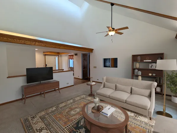 a living room with furniture a rug and a chandelier