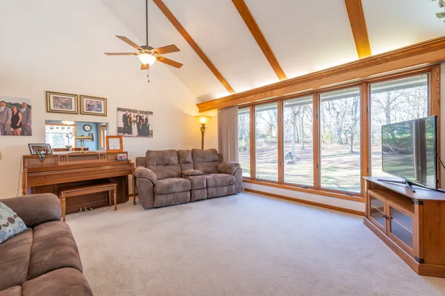 a living room with furniture and a floor to ceiling window