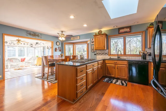 a kitchen with stainless steel appliances granite countertop a stove a sink and a refrigerator