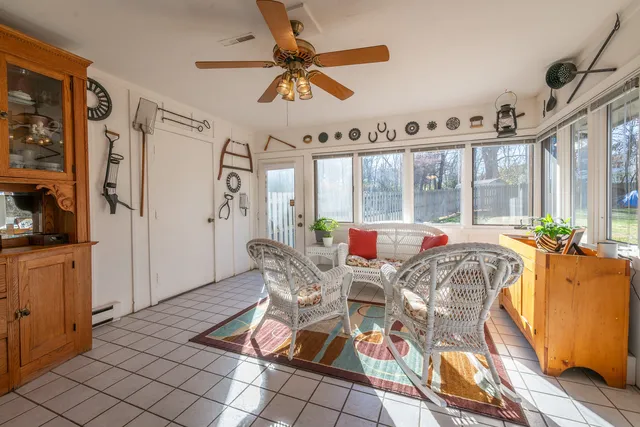 a view of a dining room with furniture a chandelier and wooden floor