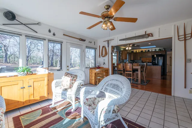 a living room with furniture and a floor to ceiling window
