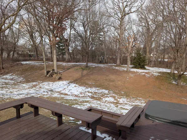 a view of a wooden deck with chairs and wooden fence