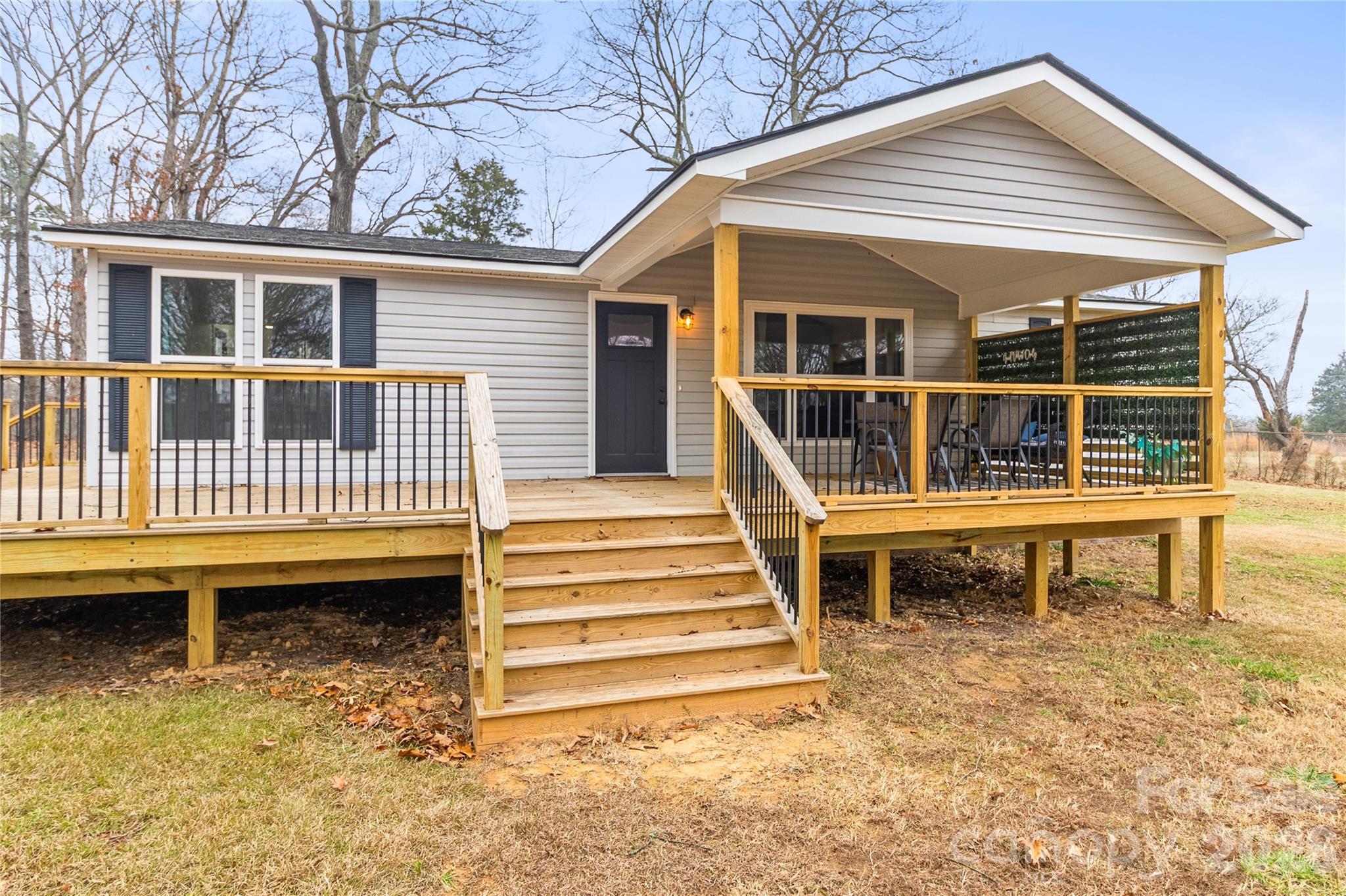 176 Odell School Road Concord, NC 28027 - Photo 1 of 46 a view of a house with a wooden deck and a large window