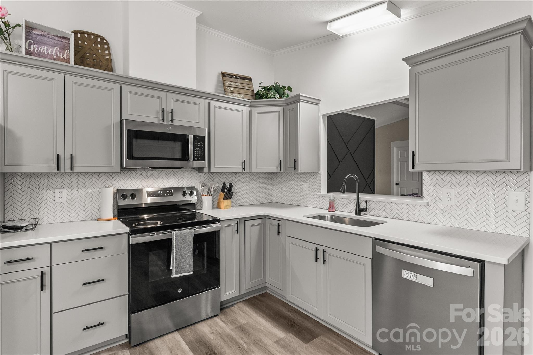 176 Odell School Road Concord, NC 28027 - Photo 17 of 46 a kitchen with a sink stove and microwave