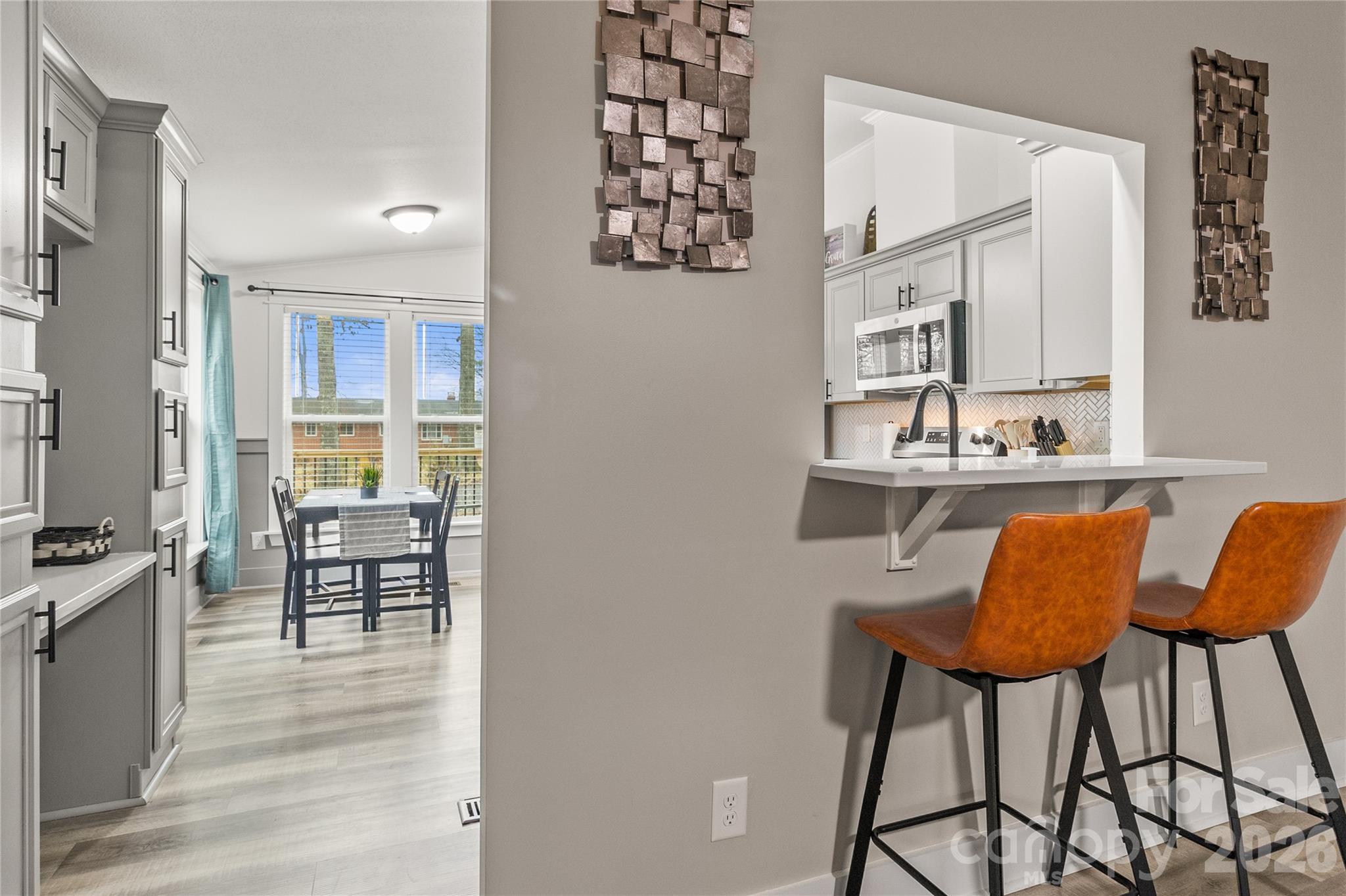 176 Odell School Road Concord, NC 28027 - Photo 18 of 46 a view of a dining room with furniture and wooden floor