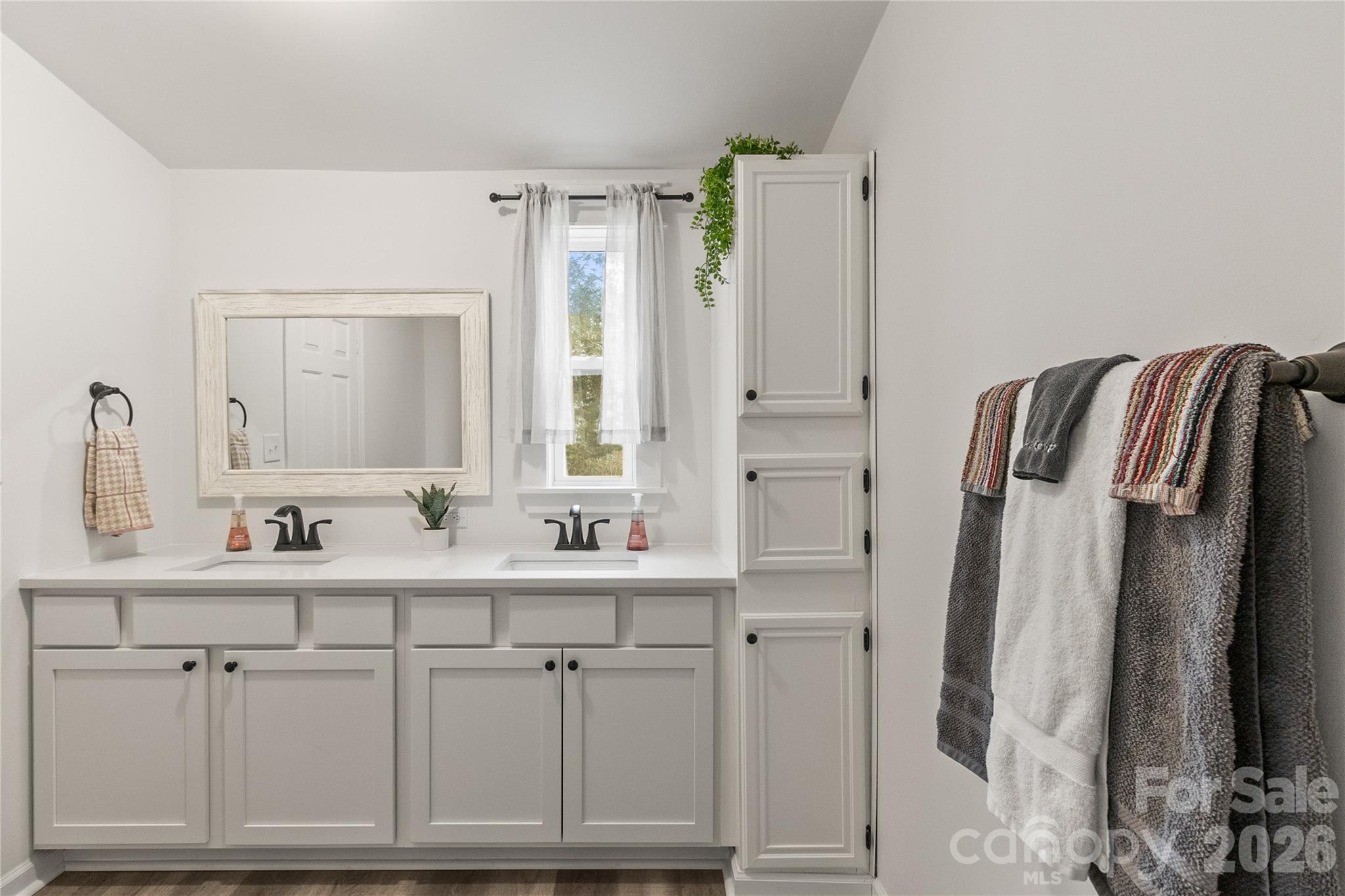 176 Odell School Road Concord, NC 28027 - Photo 30 of 46 a bathroom with a double vanity sink a mirror and a shower