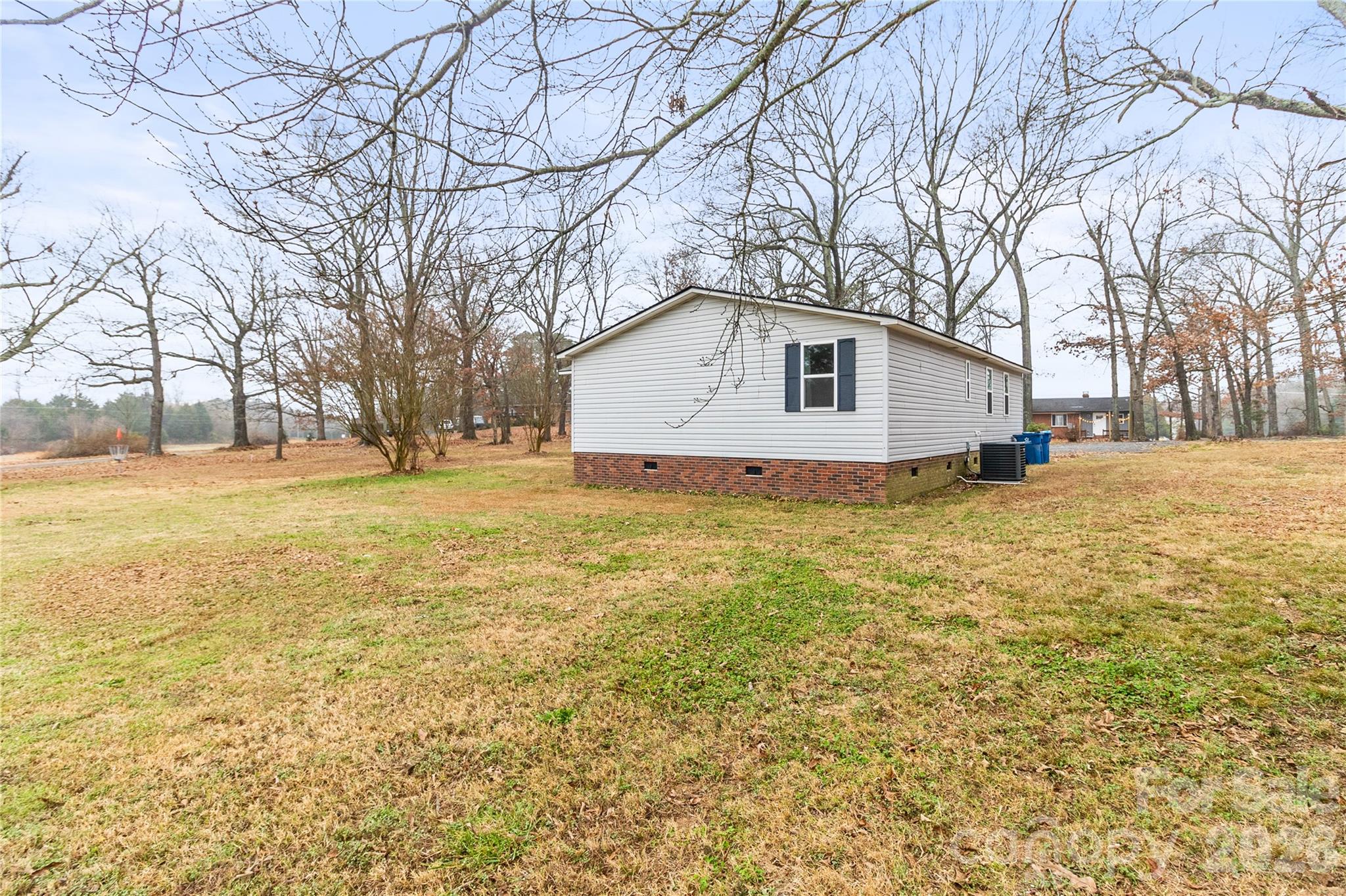 176 Odell School Road Concord, NC 28027 - Photo 41 of 46 a white house that has tree in front of it
