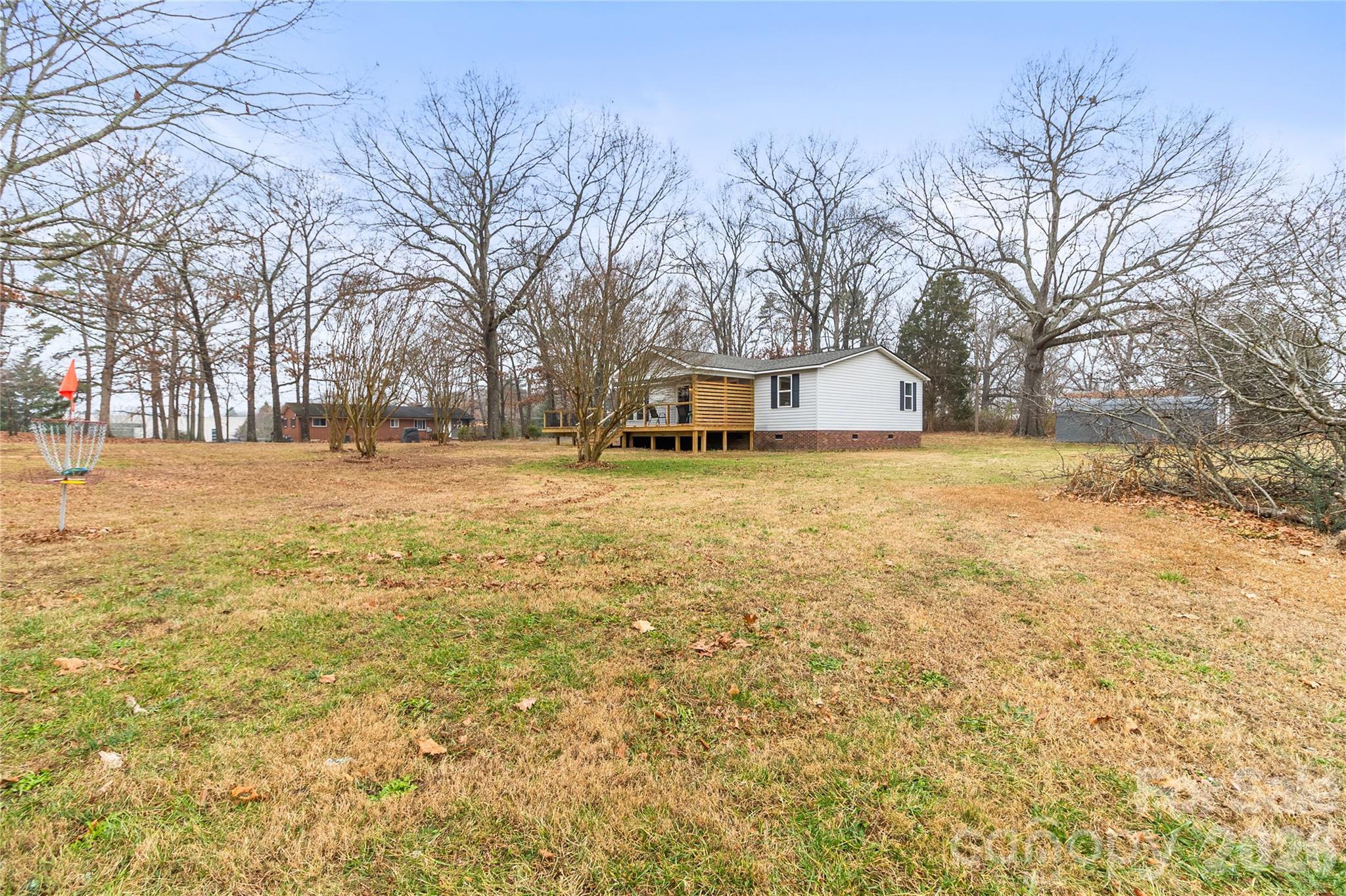 176 Odell School Road Concord, NC 28027 - Photo 5 of 46 a view of a yard with a house and large trees