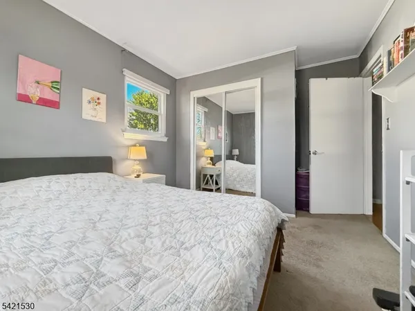 a bedroom with a bed and a view of bathroom