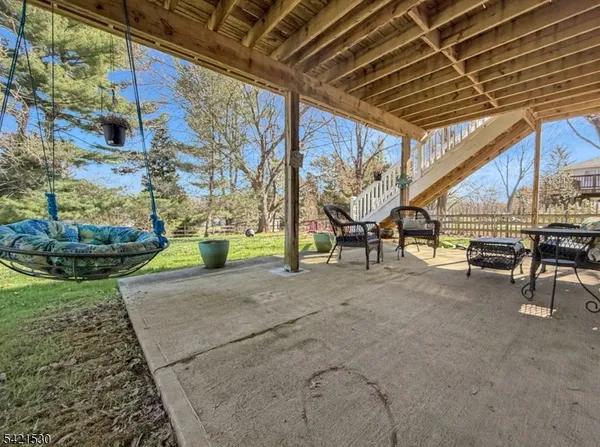 a view of a patio with table and chairs and potted plants