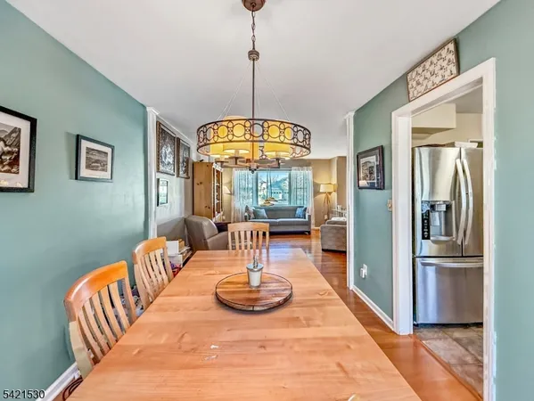 a view of a dining room with furniture wooden floor and a chandelier