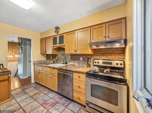 a kitchen with stainless steel appliances granite countertop a stove and a sink