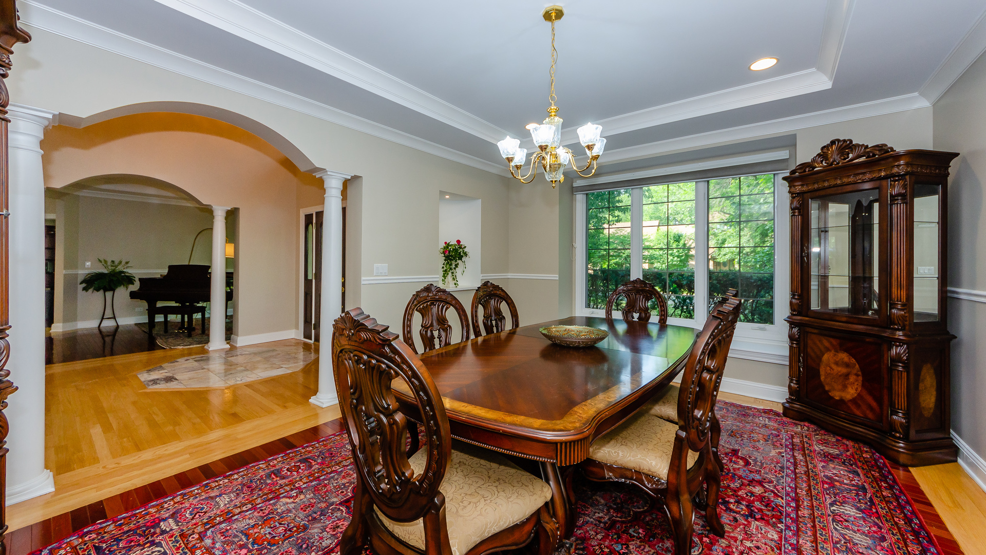 230 Devon Drive Burr Ridge, IL 60527 - Photo 15 of 94 a dining room with furniture a chandelier and wooden floor