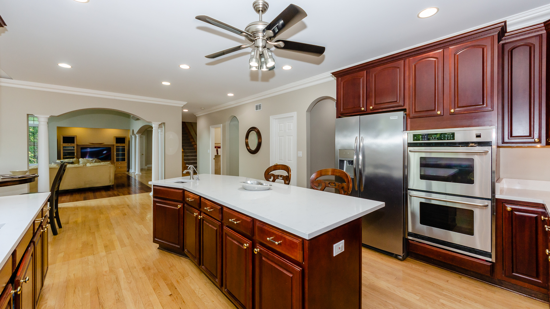 230 Devon Drive Burr Ridge, IL 60527 - Photo 20 of 94 a large kitchen with stainless steel appliances a stove a refrigerator a oven and a sink with wooden floor