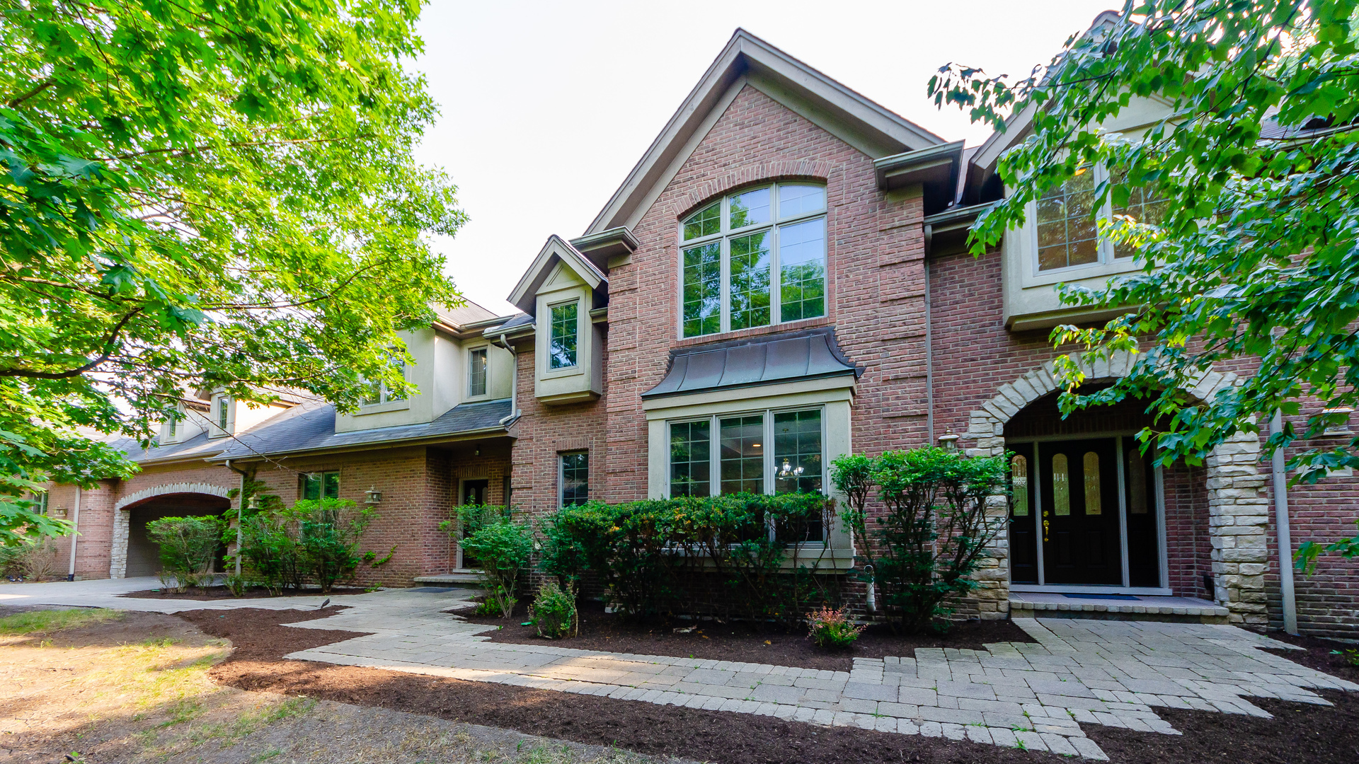 230 Devon Drive Burr Ridge, IL 60527 - Photo 2 of 94 a front view of a house with garden