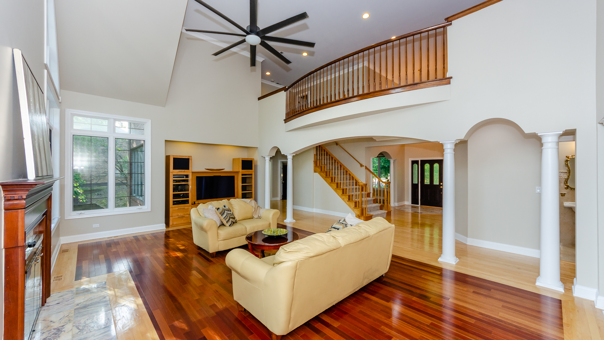 230 Devon Drive Burr Ridge, IL 60527 - Photo 27 of 94 a living room with furniture floor to ceiling window and wooden floor