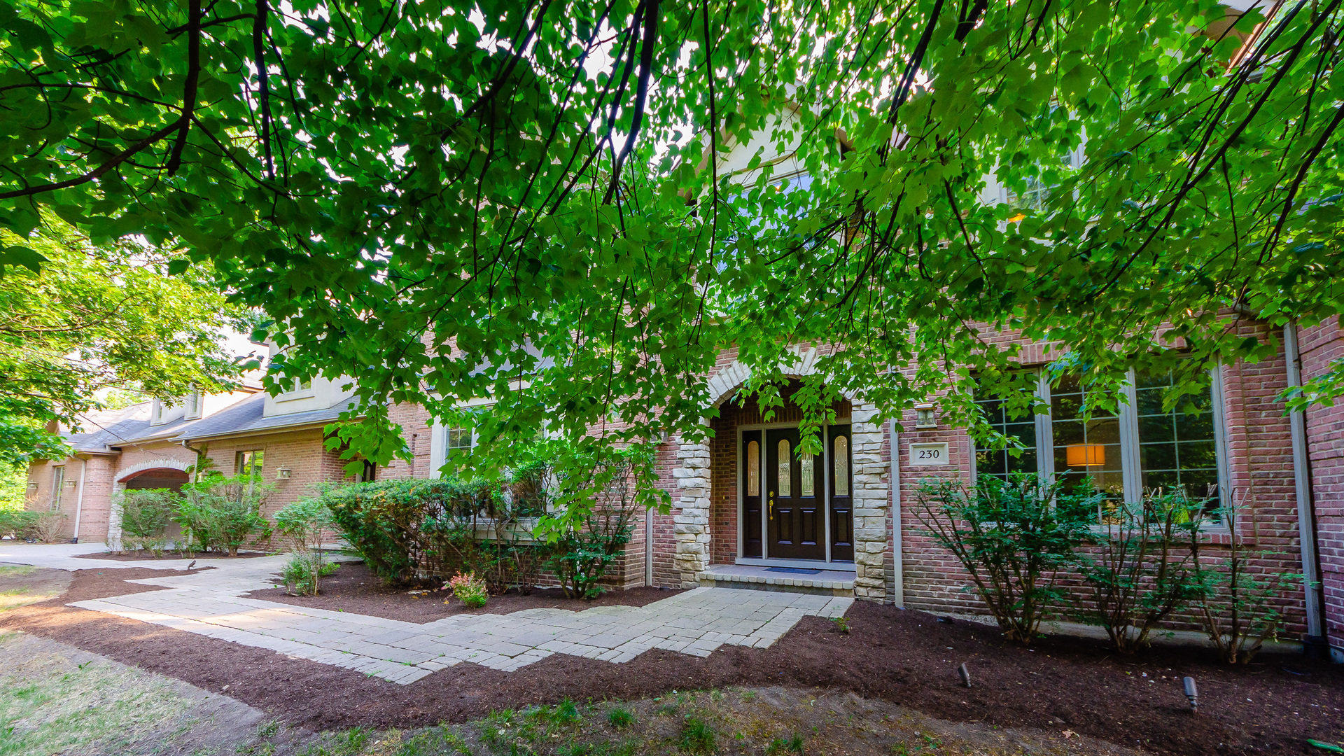 230 Devon Drive Burr Ridge, IL 60527 - Photo 3 of 94 a front view of a house with garden