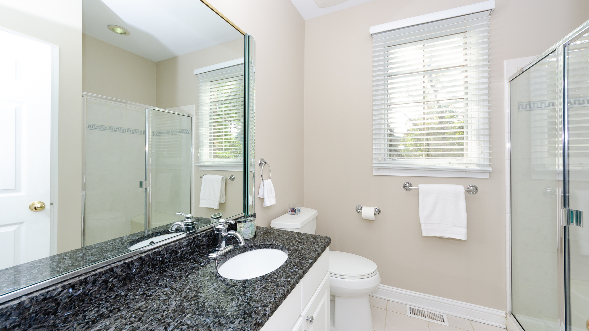 230 Devon Drive Burr Ridge, IL 60527 - Photo 34 of 94 a bathroom with a granite countertop sink toilet and mirror
