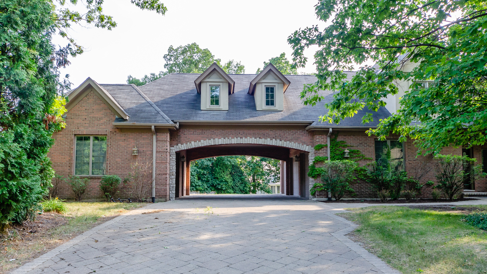 230 Devon Drive Burr Ridge, IL 60527 - Photo 5 of 94 a front view of a house with a garden