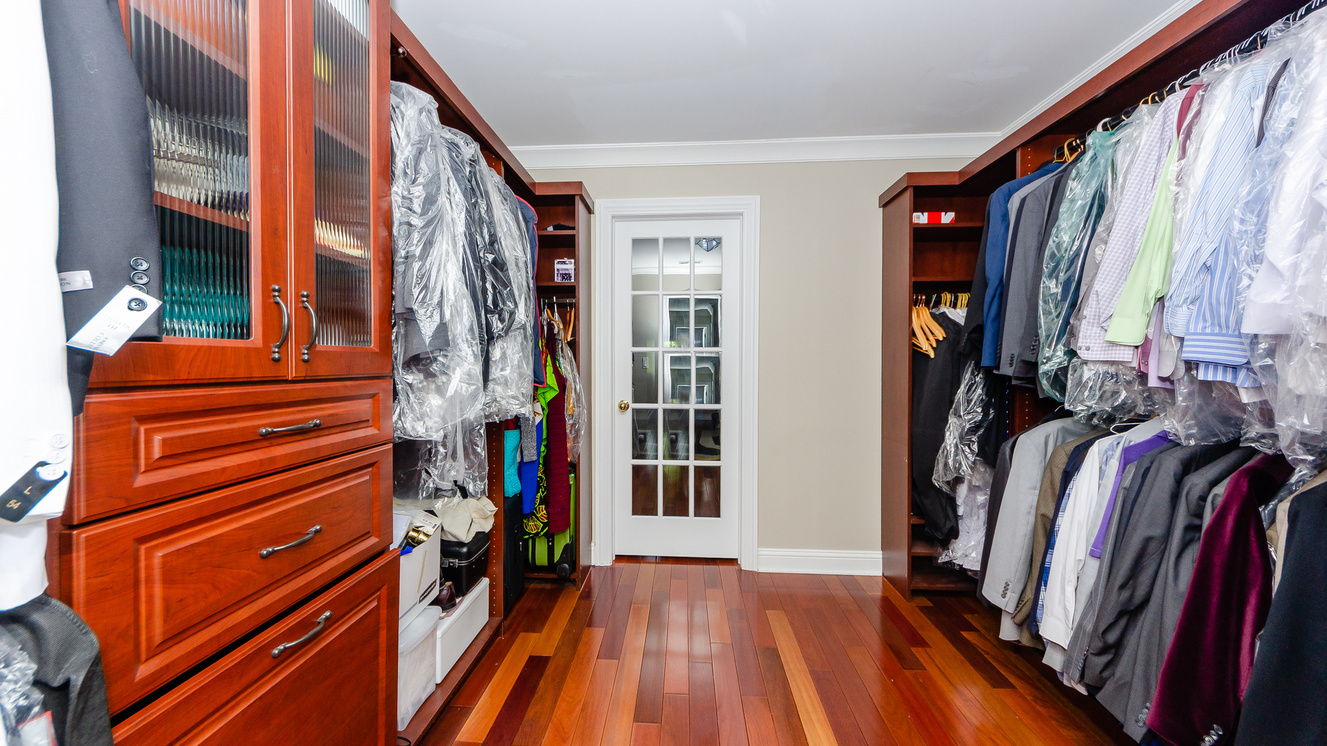 230 Devon Drive Burr Ridge, IL 60527 - Photo 64 of 94 a view of walk in closet with clothes and shoes