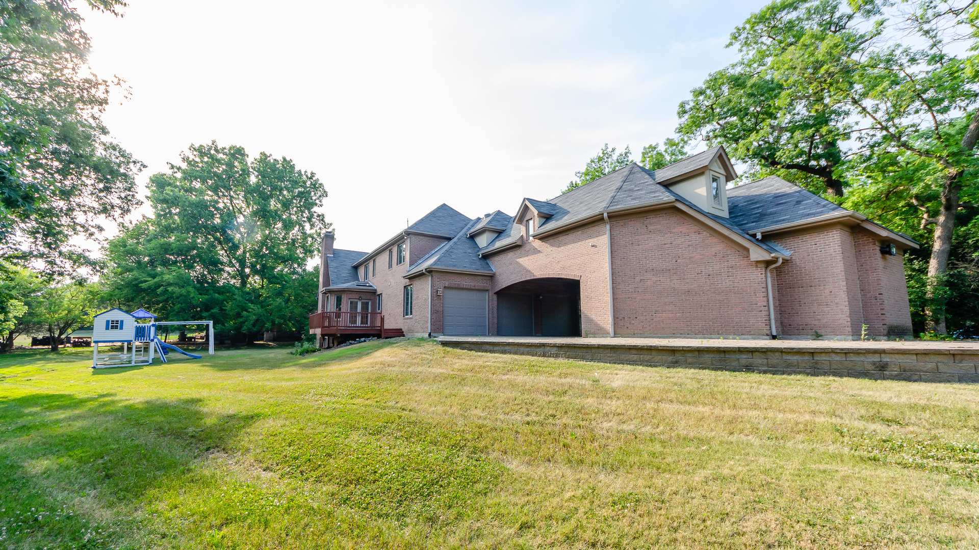 230 Devon Drive Burr Ridge, IL 60527 - Photo 85 of 94 a front view of house with yard and trees in the background