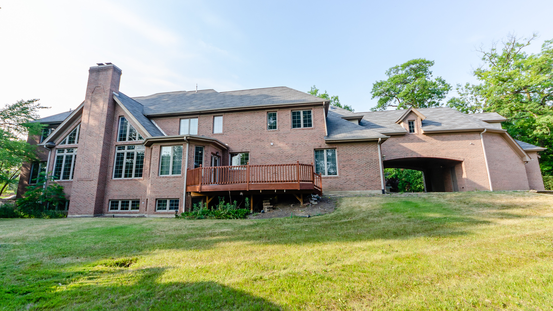 230 Devon Drive Burr Ridge, IL 60527 - Photo 87 of 94 a front view of a house with a garden and a yard