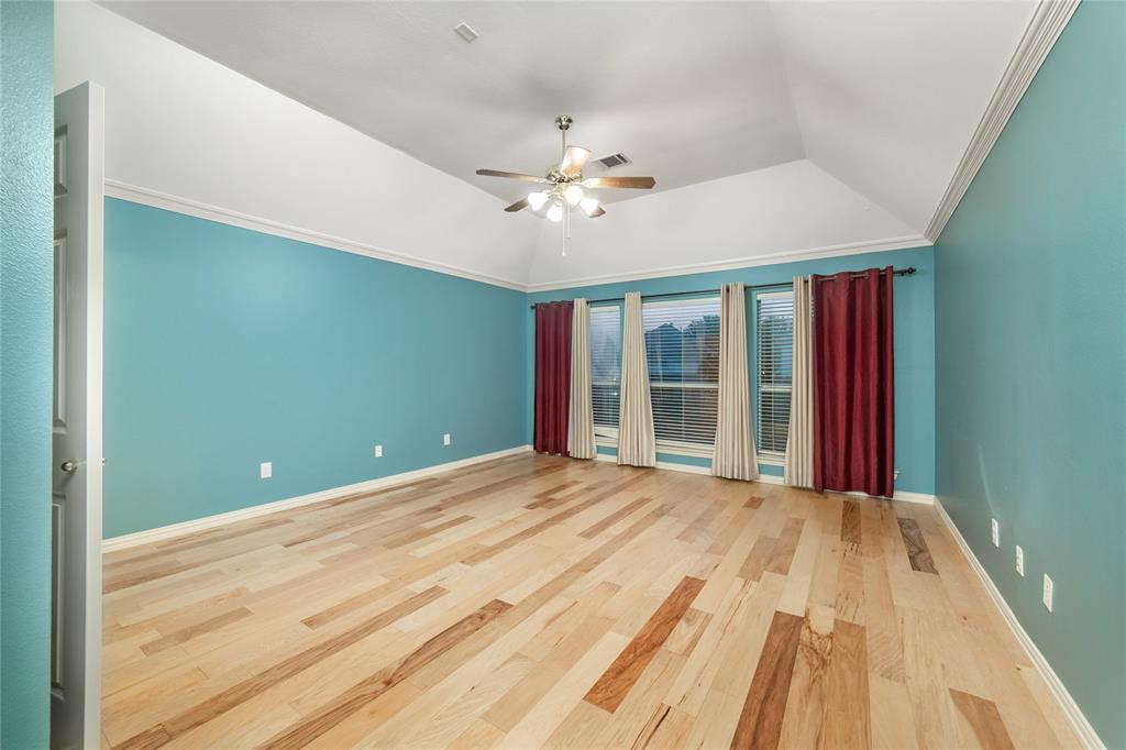 5801 Yeary Road Plano, TX 75093 - Photo 23 of 33 Spacious room featuring vaulted ceilings, light wood-finish flooring, and crown molding