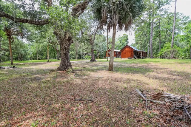 a backyard of a house with yard and outdoor seating