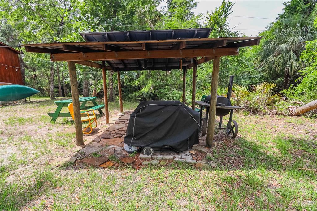 3850 Southeast 22 Court Bronson, FL 32621 - Photo 15 of 40 a view of backyard with table and chairs under an umbrella