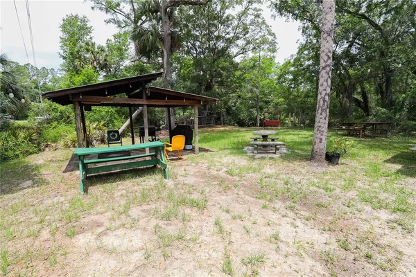 a view of a wooden house with a yard