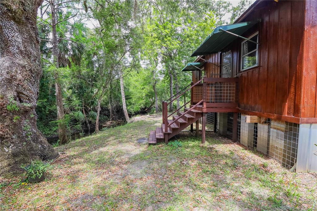 3850 Southeast 22 Court Bronson, FL 32621 - Photo 17 of 40 a view of a wooden house with a yard