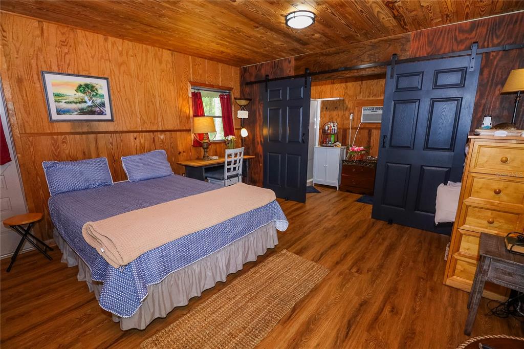 3850 Southeast 22 Court Bronson, FL 32621 - Photo 19 of 40 a bedroom with bed and wooden floor