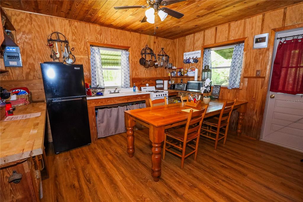 3850 Southeast 22 Court Bronson, FL 32621 - Photo 21 of 40 a dining room with furniture a window and wooden floor