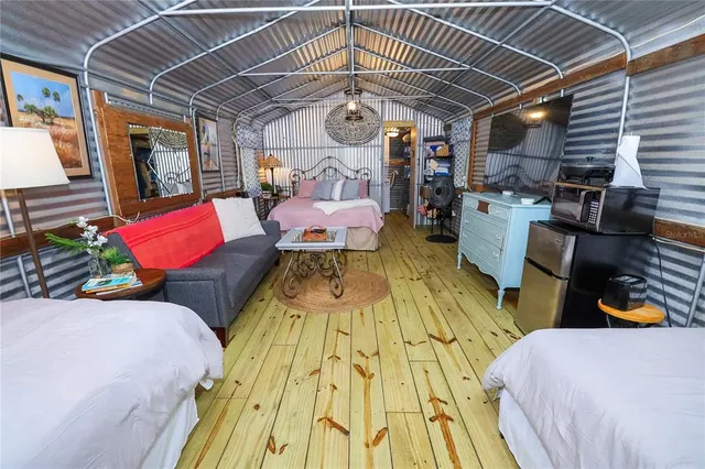 a bed room with a bed and wooden floors