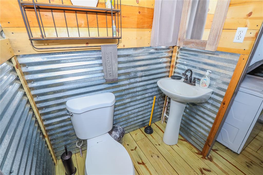 3850 Southeast 22 Court Bronson, FL 32621 - Photo 37 of 40 a bathroom with a sink a toilet and mirror